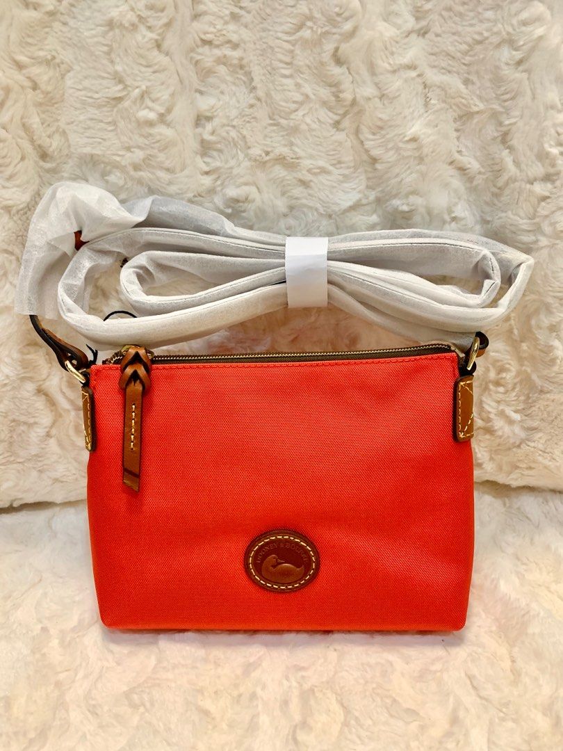 Dooney and Bourke Nylon Crossbody (Category: Cross-body Bags) located in San Fernando. Submitted by sheydm18 (Listing ID 1234171309, Image 1). Description: Guaranteed Original Brand New Dooney and Bourke Nylon Cross Body Bag Colors: Red, Khaki ✅ This is the perfect everyday bag! ✅ Light weight and easy to carry around! ❤️💛 ✅ Comes with the signature Dooney Leather Duck! A definite must have! Sf c/o buyer Available for shopee check out (sf only) 
