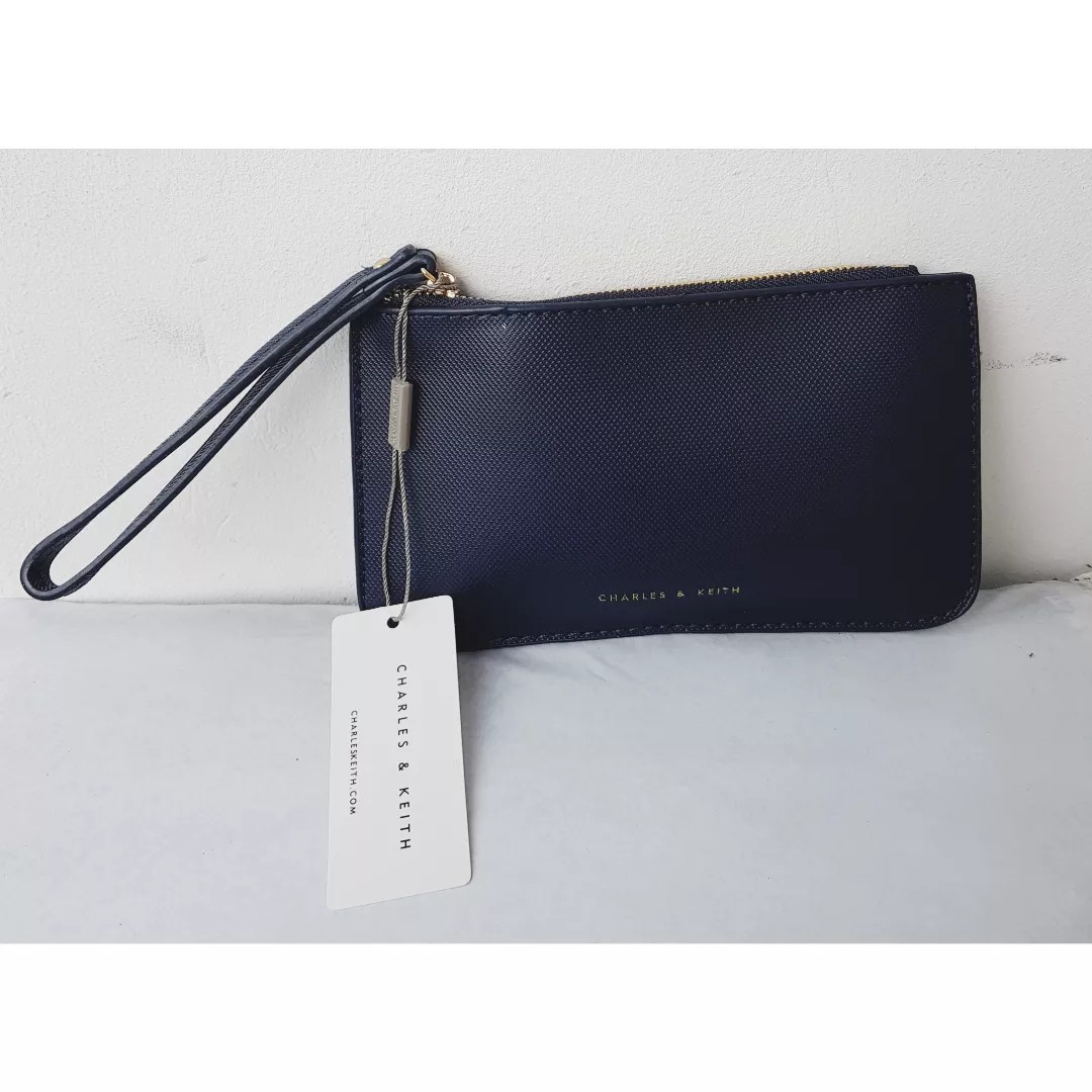 CHARLES&KEITH POUCH SNAKES SKIN. on Carousell