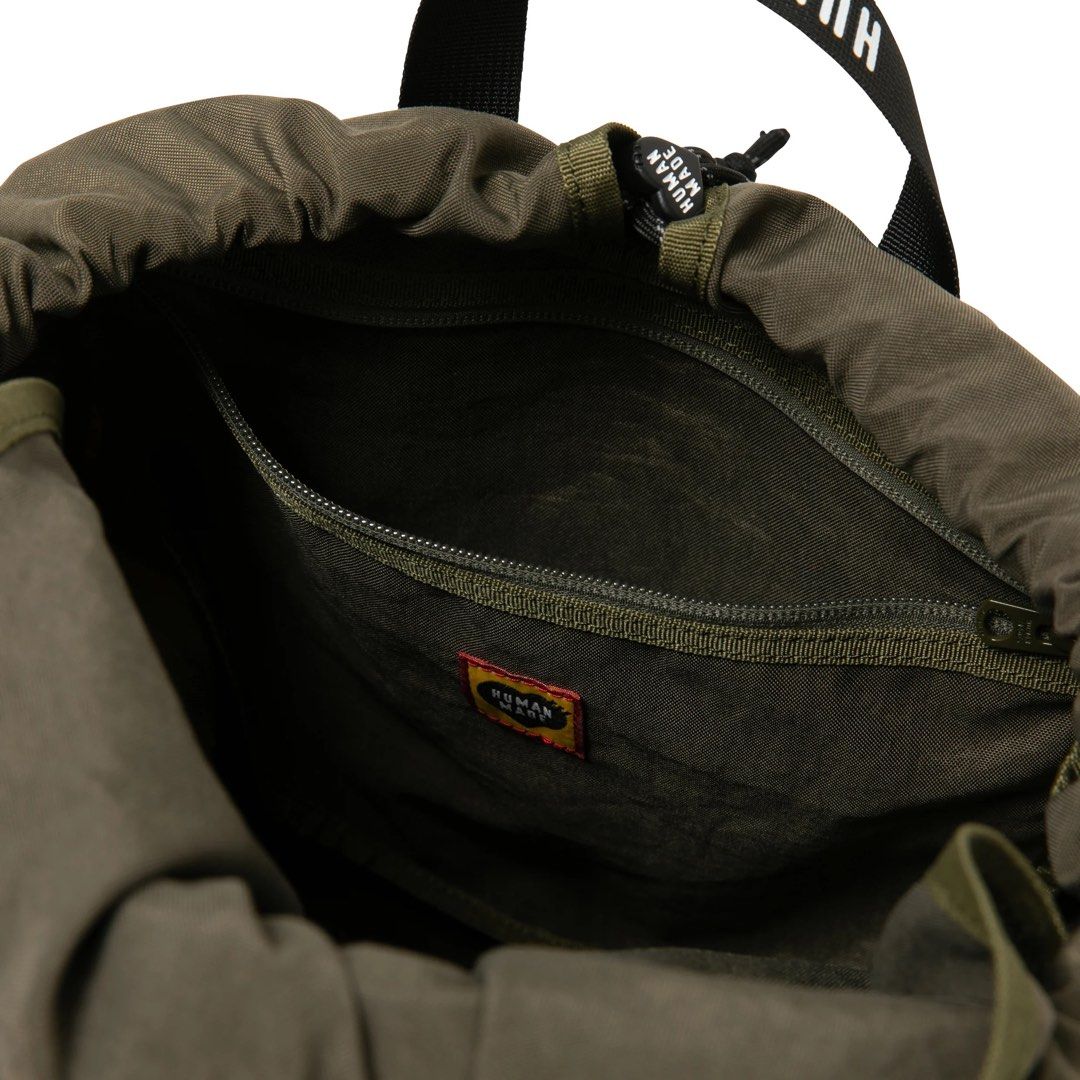 HUMAN MADE DRAWSTRING BACKPACK (Category: Backpacks) located in Singapore. Submitted by nichloesg (Listing ID 1234595499, Image 7). Description: ✅ Olivedrab Height 45, width 23, depth 20cm Find us at @nichloesg Tags Nigo .