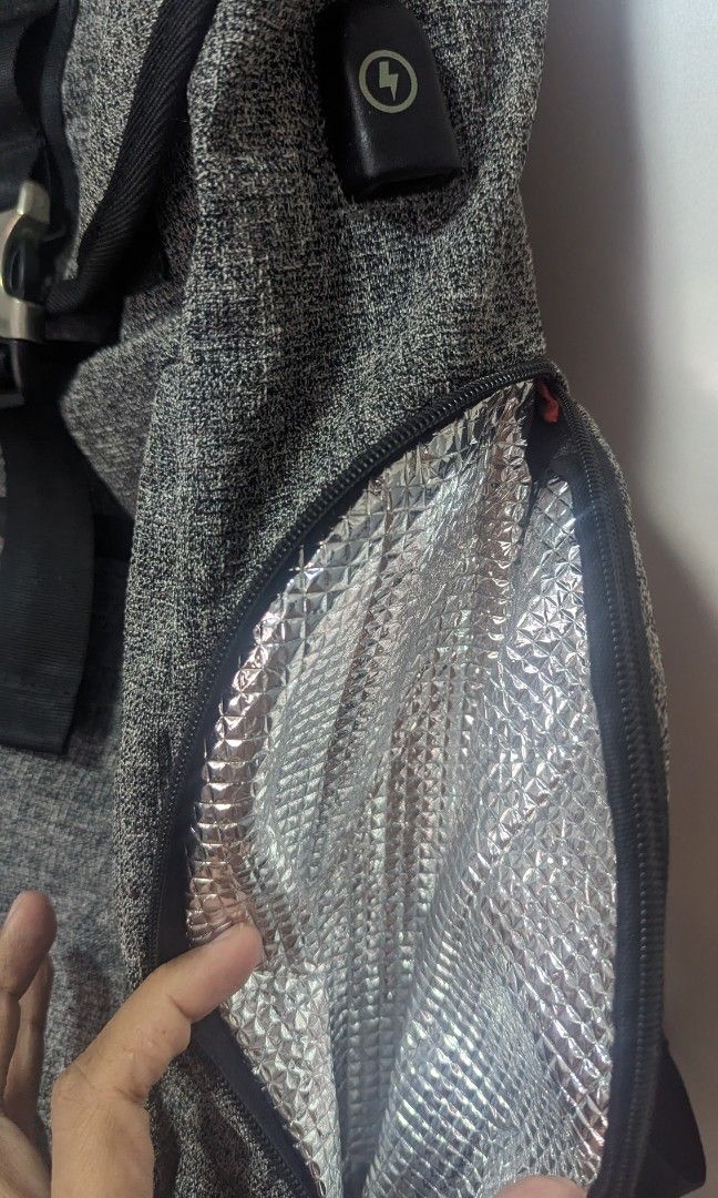 Backpack (Category: Backpacks) located in Singapore. Submitted by fatboyspidey (Listing ID 1234770412, Image 3). Description: 25L backpack, comes with a charging area at the side which one could connect it to a power bank. also, the bag allows you to store chilled items better at one of the pockets. some wear and tear seen at the top handle. zips works fine laptop segment availabe superb for work.