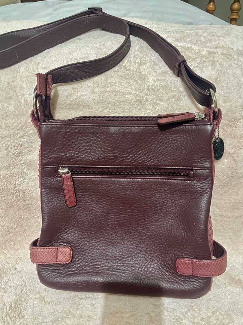 JRA maroon sling bag (Category: Luxury Bags & Wallets) located in San Pablo. Submitted by prelovedbymistyblue (Listing ID 1234951876, Image 2). Description: Like new unused condition JRA maroon sling bag. Comes with care card, hangtag. YKK zip. Has 3 compartments (2 zippered compartments and 1 with magnetic closure). made in Japan. Measures 9.2 x 9.5 x 2.5 inches. Selling low for 3800, down to 3000 and now further reduced to 2800 .