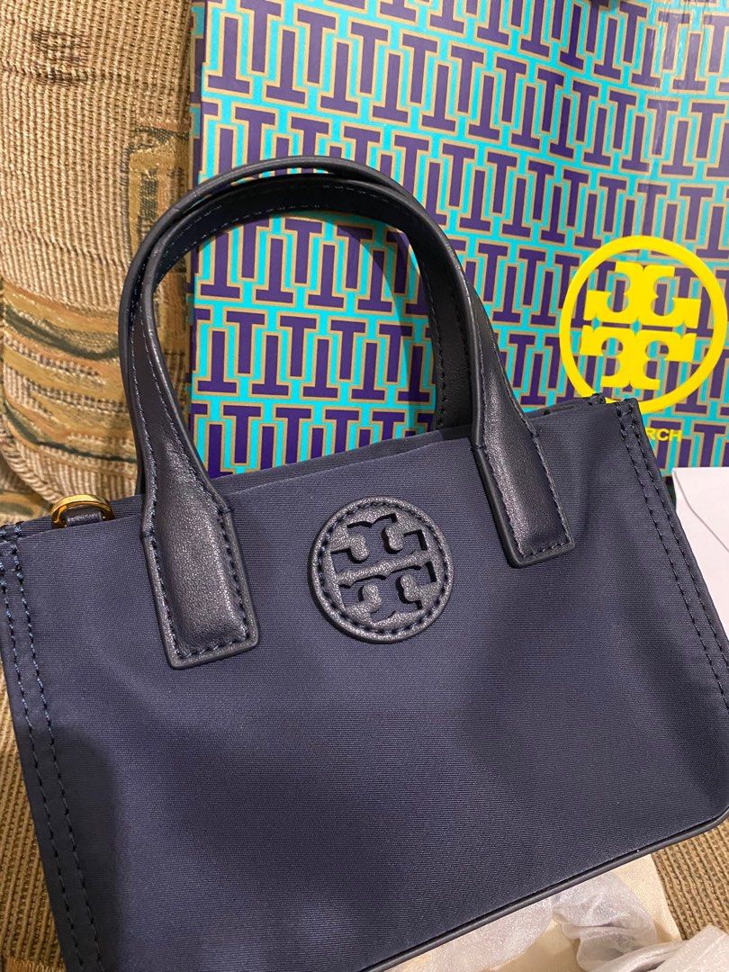Tory Burch Ella Micro (Category: Luxury Bags & Wallets) located in Manila. Submitted by ____jnsk (Listing ID 1234950641, Image 2). Description: Tory Burch Ella Micro tote - 1 main compartment, Zipper closure - Top handles with 2.8" (7 cm) drop - Removable crossbody strap with 23.1" (58 cm) drop - Dimensions: Height: 4.8" (12 cm); length: 7.2" (18 cm); depth: 2.8" (7 cm) - Comes with dust bag and paper bag - In Navy Blue color - Last price already