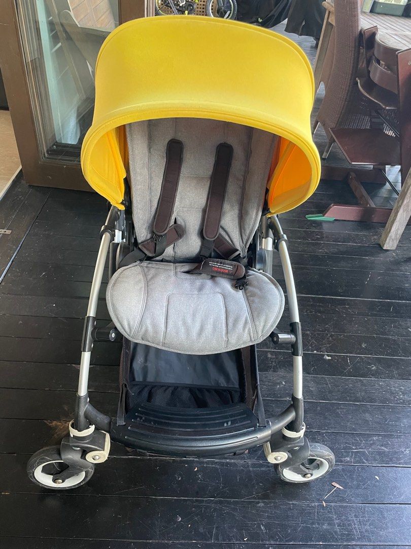 well used Bugaboo Bee5 stroller with a rain cover