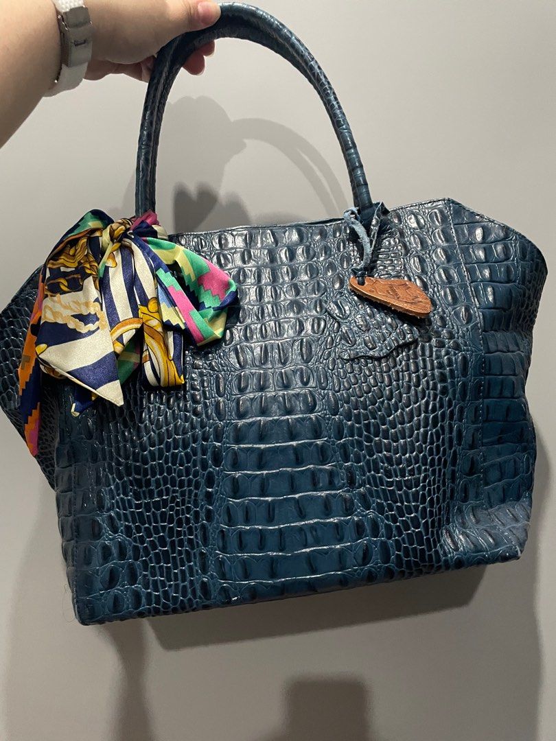Crocodile-embossed Cowhide leather handbag (Our Tribe) (Category: Tote Bags) located in Muntinlupa City. Submitted by kcshopph (Listing ID 1230526802, Image 1). Description: Crocodile-embossed Cowhide leather Used this occasionally for work. Has wear and tear signs at the zipper handle and bag edges but barely noticeable. Well-maintained by bag conditioner every use. Will condition the bag before sending. Thanks 😊 40x26cm.
