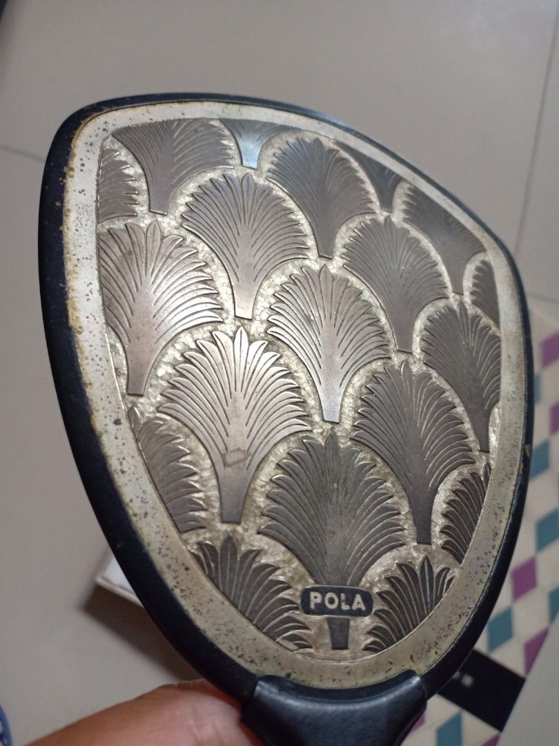Vintage Vanity Hand Mirror (Category: Makeup) located in Binangonan. Submitted by stufflikedat (Listing ID 1230358399, Image 3). Description: Vintage 1960's Pola Cosmetics (Japan) vanity hand mirror in very good condition with original box,it is made of heavy metal and has a small Pola stamp, handle made of tin metaal, the wavy peacock-like pattern is also grand and elegant. Made In Japan Crica : 1960's Size : Mirror : 34cm x 14cm Mirror in prist