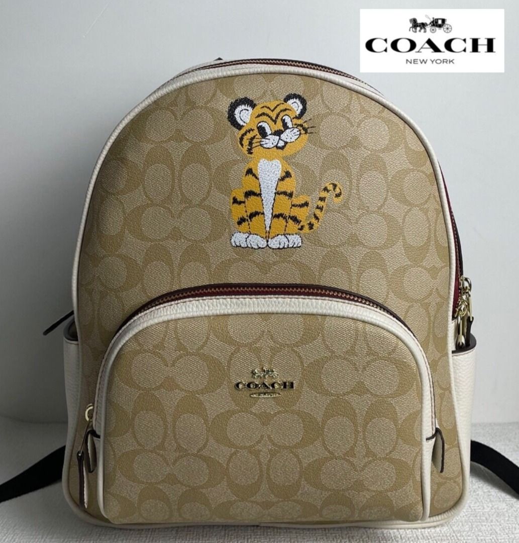 coach backpack with tiger Court In Signature Canvas Printed coated canvas and refined pebble leather Inside zip and multifunction pockets Double zip closure fabric lining Handle with 2 1/4 drop Outside zip pocket Adjustable shoulder straps 10 3/4 (L) x 12 1/2 (H) x 4 3/4 (W) Style No. COACH Court Backpack In Signature