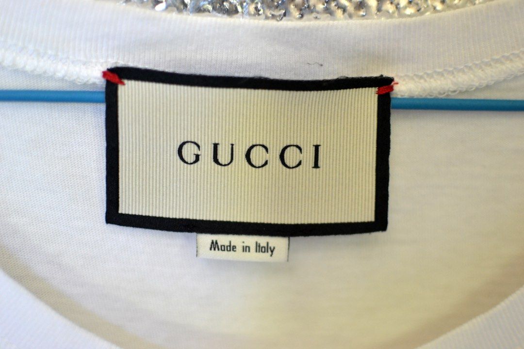 AUTHENTIC Gucci shirt (Category: Luxury Apparel) located in Akbar. Submitted by itsluxurythings (Listing ID 1230133466, Image 2). Description: 🔥ONHAND Ready to ship anytime🔥 ✅100% AUTHENTIC✅ 🩷Actual Pictures posted already 🩷 Item is in excellent condition, features is a nice Colors Green eyes Pretty Cat Sequins Patches not print., this Gucci distressed Cream color tshirt is you have like it because the cat is so so pretty in personal looks ve