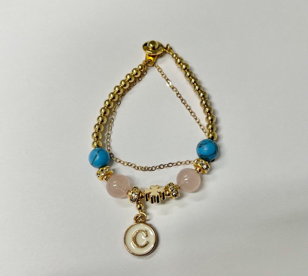 Turquoise and Rose Quartz Bracelet (Category: Bracelets) located in San Juan City. Submitted by nbc88 (Listing ID 1230930869, Image 1). Description: Turquoise and rose quartz bracelet with “C” charm and clover leaf. Bracelet length: 16cm.