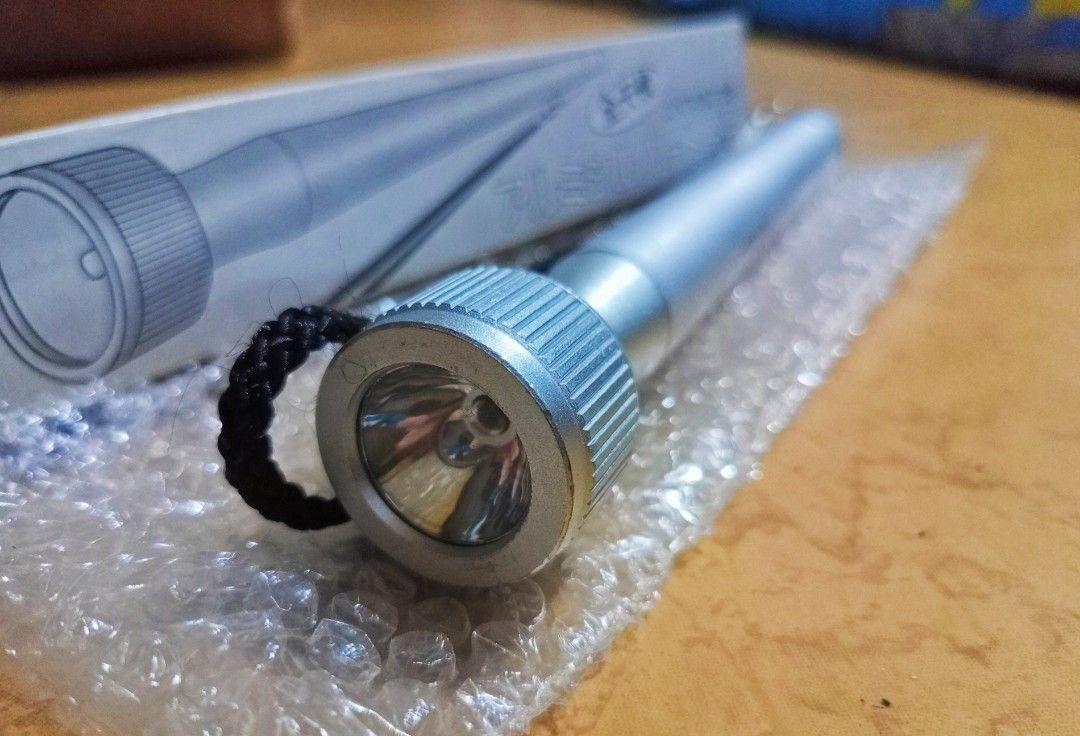 Flashlight Japan Surplus (Category: Lighting) located in Silang. Submitted by pickright (Listing ID 1236944565, Image 1). Description: Tested 100% working. Seven-inch sturdy flashlight from Japan. Its body is made up of Aluminum Alloy. It has a spare bulb secured inside the piece of metal tube located at its string. Please see photos provided. No battery included..