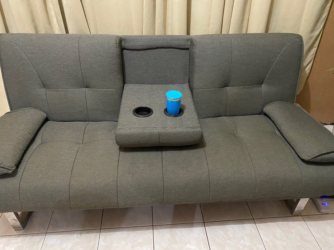 Gray sofa bed with cup holders on Carousell
