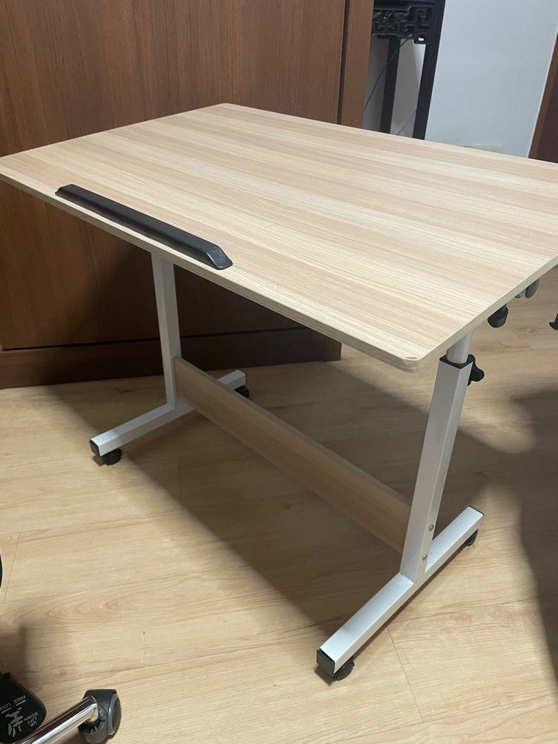Height adjustable, foldable , portable table (Category: Tables & Sets) located in Singapore. Submitted by rrrsrrr (Listing ID 1237104062, Image 1). Description: Height can be manually adjusted from 65-87cm. Tabletop is 80*50cm Foldable, compact to keep. You can tilt at certain angle as well, which I used for laptop. Comes with wheels, easy to watch stuff at bedside. Wheels are lockable. Bought this at 60+ and used for a year. Selling it because I