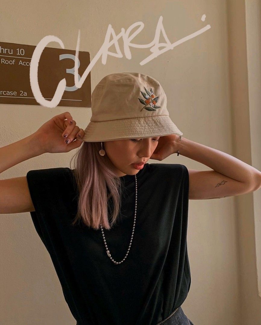 Girl wearing bucket discount hat