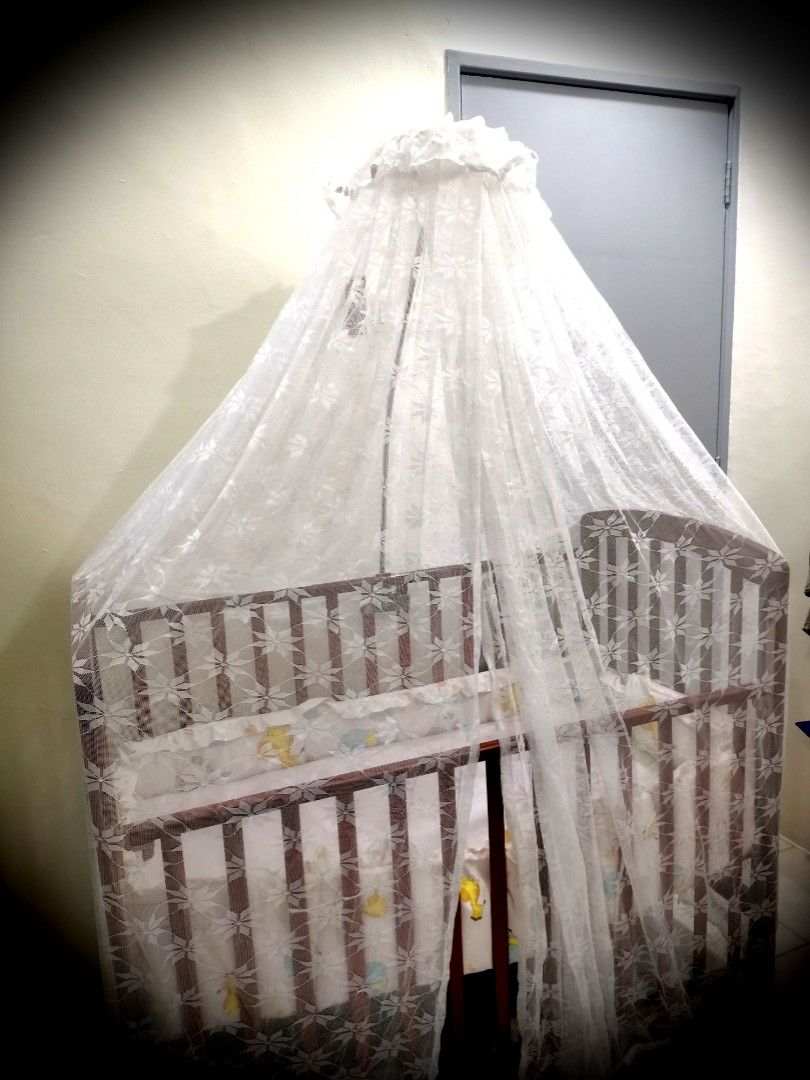 Wooden cot with mosquito outlet net