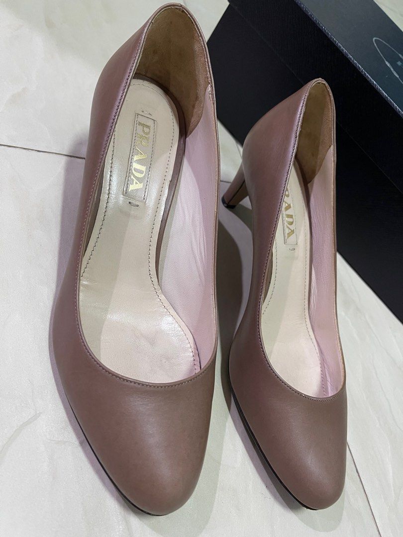 Prada Heels (Category: Heels) located in Singapore. Submitted by elmobubuyier (Listing ID 1237296080, Image 2). Description: Authentic. Made in Italy. Size 36.5 with box. Underutilised. Used for 3 times. Heels require repair (see picture 6). One defect see picture (see picture 4)..