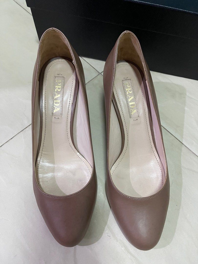 Prada Heels (Category: Heels) located in Singapore. Submitted by elmobubuyier (Listing ID 1237296080, Image 9). Description: Authentic. Made in Italy. Size 36.5 with box. Underutilised. Used for 3 times. Heels require repair (see picture 6). One defect see picture (see picture 4)..