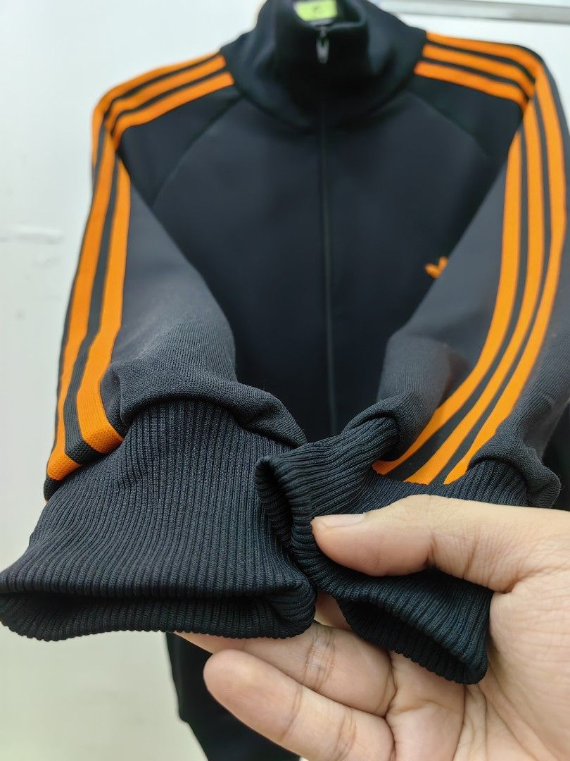 Black adidas jacket hot sale with orange stripes