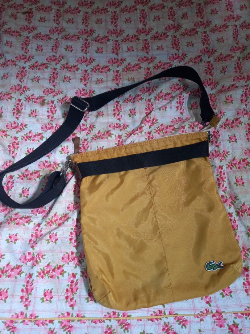 Authentic Lacoste L!VE Sling Bag (Category: Sling Bags) located in Marilao. Submitted by MusicAndThings (Listing ID 1236170722, Image 1). Description: Mustard Yellow Color Unisex Nylon Material.