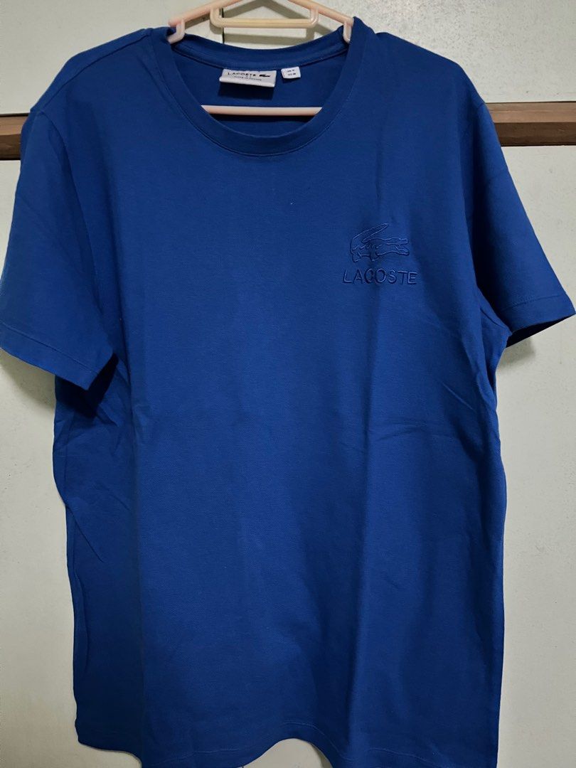 Lacoste T-Shirt (Category: Tshirts & Polo Shirts ) located in Makati City. Submitted by romadeclutters (Listing ID 1237913942, Image 2). Description: Lacoste T-shirt Size 4 - Medium Asian Size (loose fit) Can fit to Large Monotone logo and with croc logo at the back Royal Blue RFS: Decluttering and not my type of design .