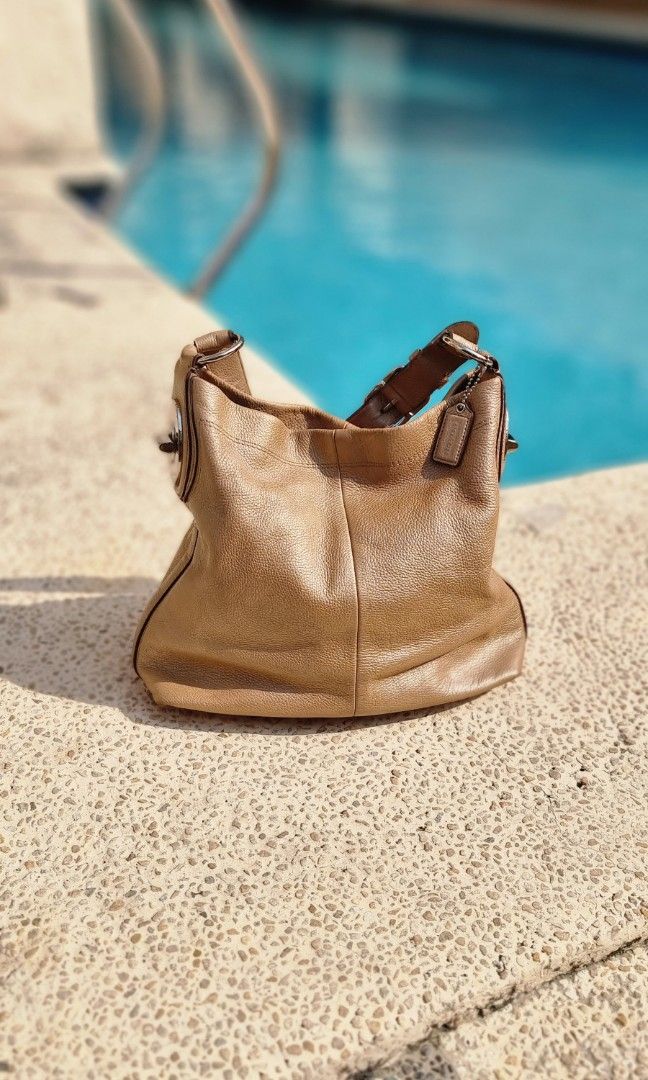 Coach Penelope in Pebble Leather gold Authentic (Category: Luxury Bags & Wallets) located in Makati City. Submitted by lilyignacio81 (Listing ID 1238617445, Image 2). Description: Coach Penelope Turn Lock Pebble Leather Gold Hobo Shoulder Bag, is a stylish and luxurious accessory that combines functionality with exquisite design. Crafted with high-quality pebble leather, this bag is a true fashion statement. The Coach Penelope Hobo Shoulder Bag f