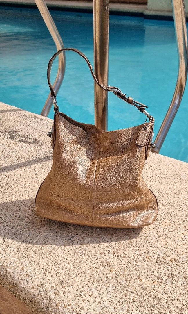 Coach Penelope in Pebble Leather gold Authentic (Category: Luxury Bags & Wallets) located in Makati City. Submitted by lilyignacio81 (Listing ID 1238617445, Image 1). Description: Coach Penelope Turn Lock Pebble Leather Gold Hobo Shoulder Bag, is a stylish and luxurious accessory that combines functionality with exquisite design. Crafted with high-quality pebble leather, this bag is a true fashion statement. The Coach Penelope Hobo Shoulder Bag f