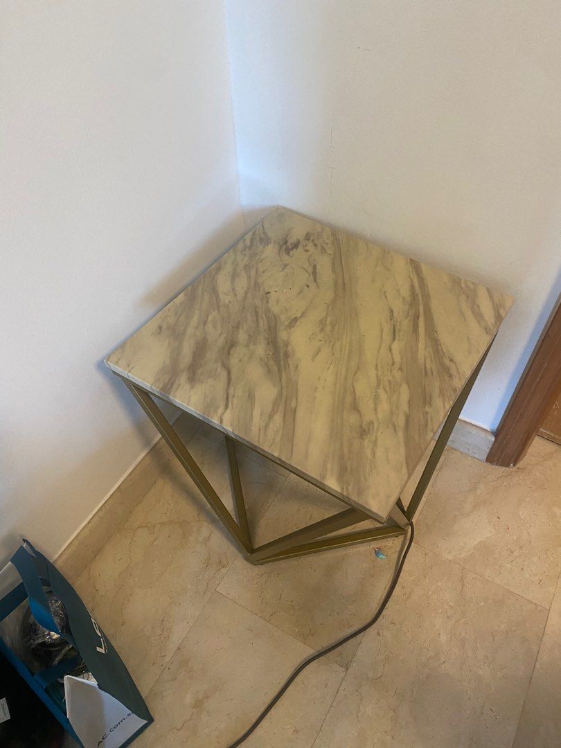 Side Table (Category: Tables & Sets) located in Singapore. Submitted by ifree1993 (Listing ID 1238690125, Image 2). Description: Faux marble side table . Gold coloured base 50cm x 50 x 50cm Height Pick up Bukit Batok.