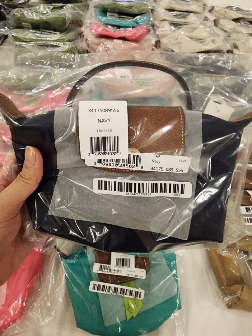 Longchamp Le Pliage Mini (Category: Luxury Bags & Wallets) located in Manila. Submitted by authenticoutletfindsph (Listing ID 1239145809, Image 2). Description: Longchamp Le Pliage Mini Pouch 4900 1300 strap sold separately (generic only) Onhand items Price Tag intact and sealed.