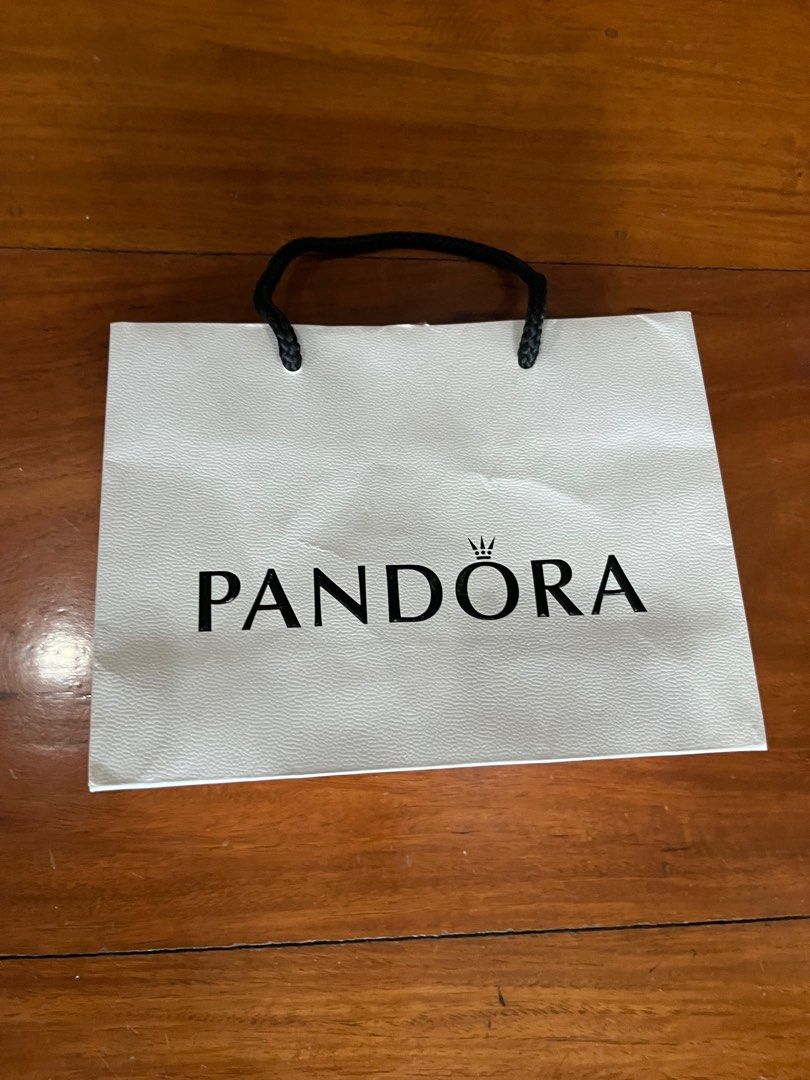 PANDORA PAPER BAG (Category: Luxury Bags & Wallets) located in Makati City. Submitted by cashfrancefashioncosmetics_ph (Listing ID 1239328999, Image 1). Description: PANDORA PAPER BAG WITH RIBBON SIZE IS 6 1/2INCHES .