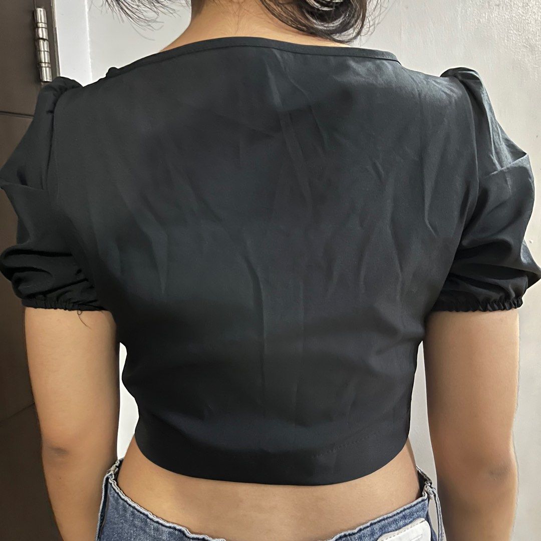 Shein black blouse top with puff sleeves (Category: Blouses) located in Taytay. Submitted by mimiccart (Listing ID 1239864173, Image 2). Description: fits S to M, black crop blouse, great for clubbing and parties, secured by front clasps and with garter ang sleeves. Brand: shein mod: jnt, ggx, sco, llmove pm me for price nego!.