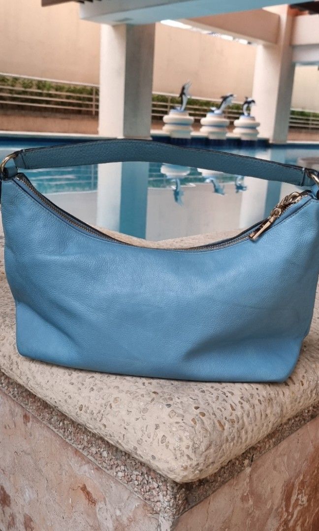 Coach East West Celeste 2 way Hobo bag (Category: Luxury Bags & Wallets) located in Makati City. Submitted by lilyignacio81 (Listing ID 1240062514, Image 2). Description: Coach East West Celeste Convertible Hobo Shoulder Bag in the stunning shade of Azure Blue. This bag combines style and functionality, offering a versatile accessory for your everyday needs. The Coach East West Celeste Convertible Hobo Shoulder Bag features a spacious and practic