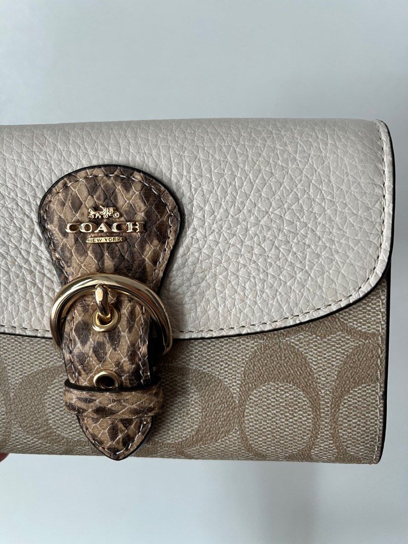 Original Coach Wallet (Category: Luxury Bags & Wallets) located in Taguig. Submitted by prelovedcloset2 (Listing ID 1239963705, Image 3). Description: Authentic Bought in the USA :) Has very minor flaws from storage - see photos. Retails for 250USD or Php 14k Signature coated canvas refined pebble leather and snake-embossed leather Four credit card slots Inside open pockets Inside zip coin pocket Snap closure Outside open pocket 6 (L) x 3 3/4 (H)