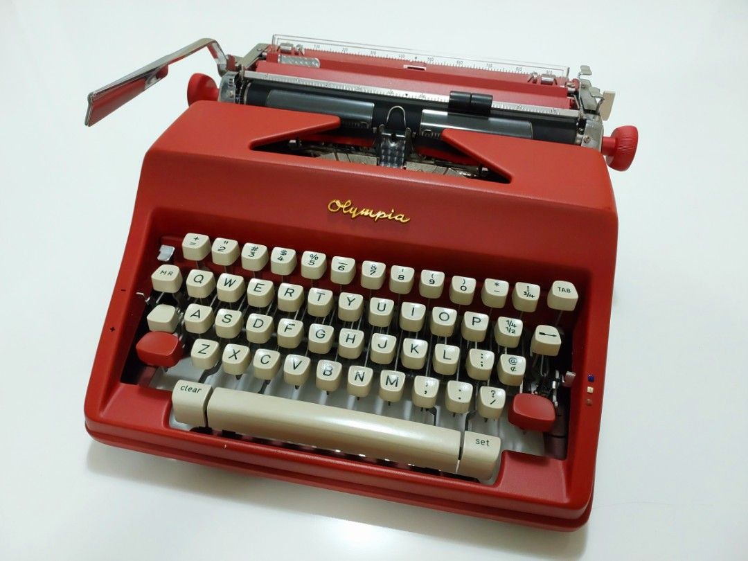 Vintage Typewriter Olympia SM9 (Category: Office & Business Technology) located in Quezon City. Submitted by owlvintage (Listing ID 1240105423, Image 1). Description: Vintage Typewriter Olympia SM9 Made in Germany. Sold as is. Vintage & refurbished. custom painted in Matte Red and Gold on the logo. Payment by Gcash. Shipping costs shouldered by buyer. Pick up in Quezon City. Thank you..