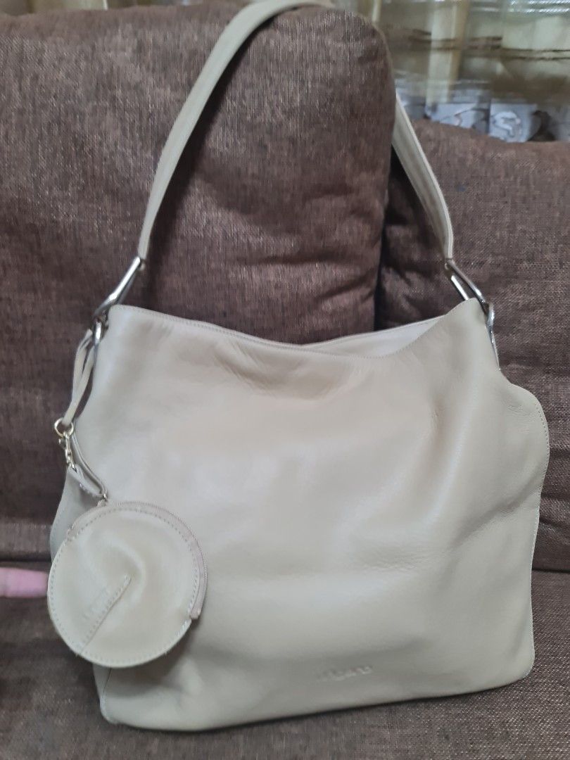 Ungaro leather bag (Category: Luxury Bags & Wallets) located in San Pablo. Submitted by ShopbyLiz (Listing ID 1235328836, Image 2). Description: beige color magnet closure has 3pockets inside 1 back pocket comes with coin purse.