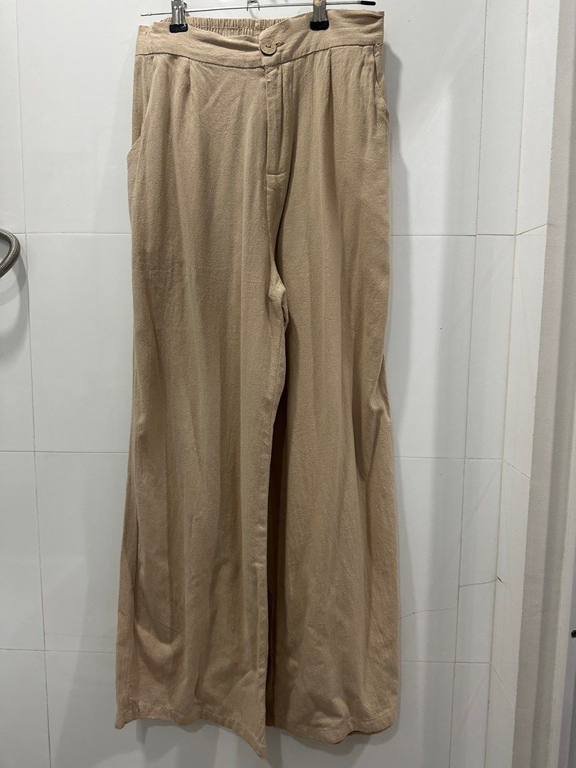 Beige Wide Leg Pants (Category: Other Bottoms) located in Quezon City. Submitted by patbrandeditems (Listing ID 1235836095, Image 3). Description: Breathable Linen fabric Garterized back With pockets Has slight himulmul at the botton .