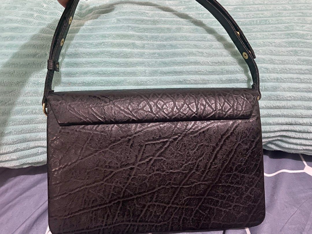 Elephant leather shoulder bag (Category: Luxury Bags & Wallets) located in San Pablo. Submitted by prelovedbymistyblue (Listing ID 1236148708, Image 2). Description: Super nice 2- way elephant leather bag. May be used as a baguette or can be adjusted as a shoulder bag. Had 2 compartments. Hardwares are still very good. The main flaw: signs of use on the leather inside the bag. Japan preloved. Selling low for 730. .