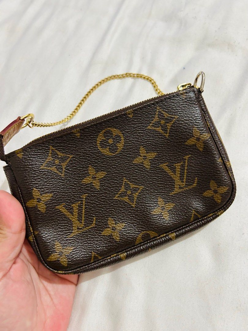 RUSH LV Mini Pochette (Category: Luxury Bags & Wallets) located in Subic. Submitted by luxbytasha (Listing ID 1221122490, Image 2). Description: - Authentic Louis Vuitton Monogram Pouch - Includes original Louis Vuitton box and dust bag - Features elegant gold chain detail - Perfect for carrying essentials - Versatile for a night out or organizing a larger bag Disclaimer: @luxbytasha is not affiliated or endorsed with any of the brands featured o