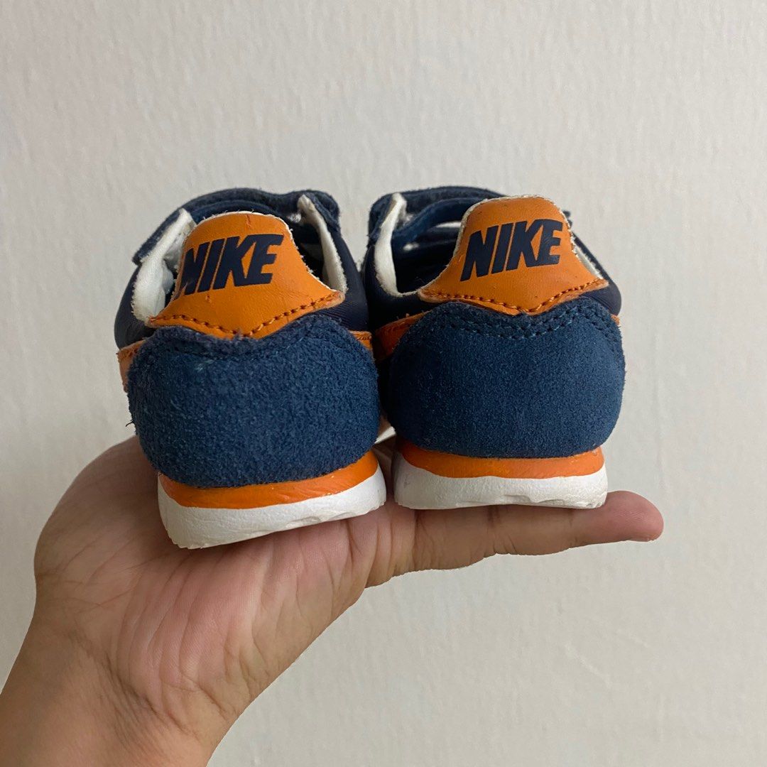 Navy blue and yellow nike cortez 2025