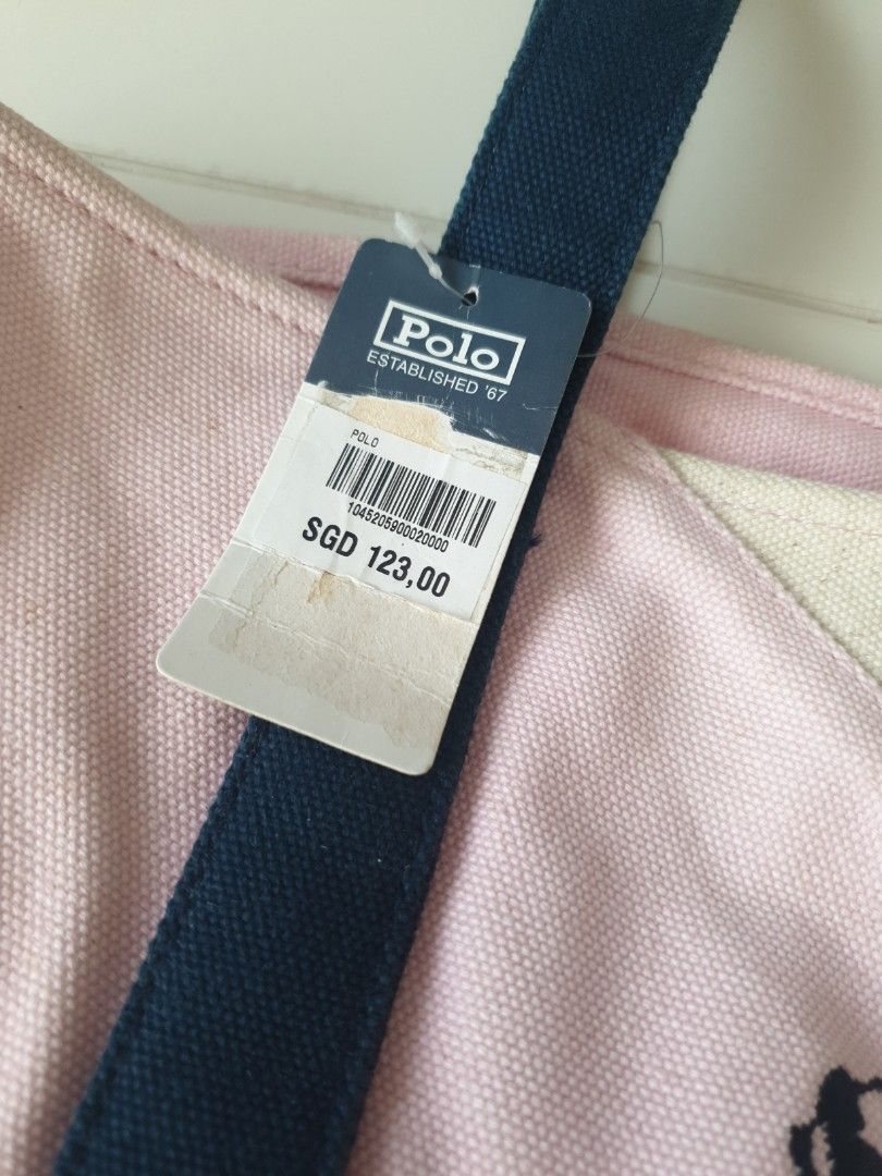 Polo Canvas Tote Bag (Category: Bags & Wallets) located in Singapore. Submitted by monchiichi (Listing ID 1236244591, Image 2). Description: Its brand new. However there's discolouration and yellow spots, thus the reduced price. I believe a wash would do the trick. Do not buy if you cannot accept it. It has a hard cardboard base and can sit upright Inner has a zipped pocket with 2 smaller pockets. length 33cm height 29cm width 14cm handle length 