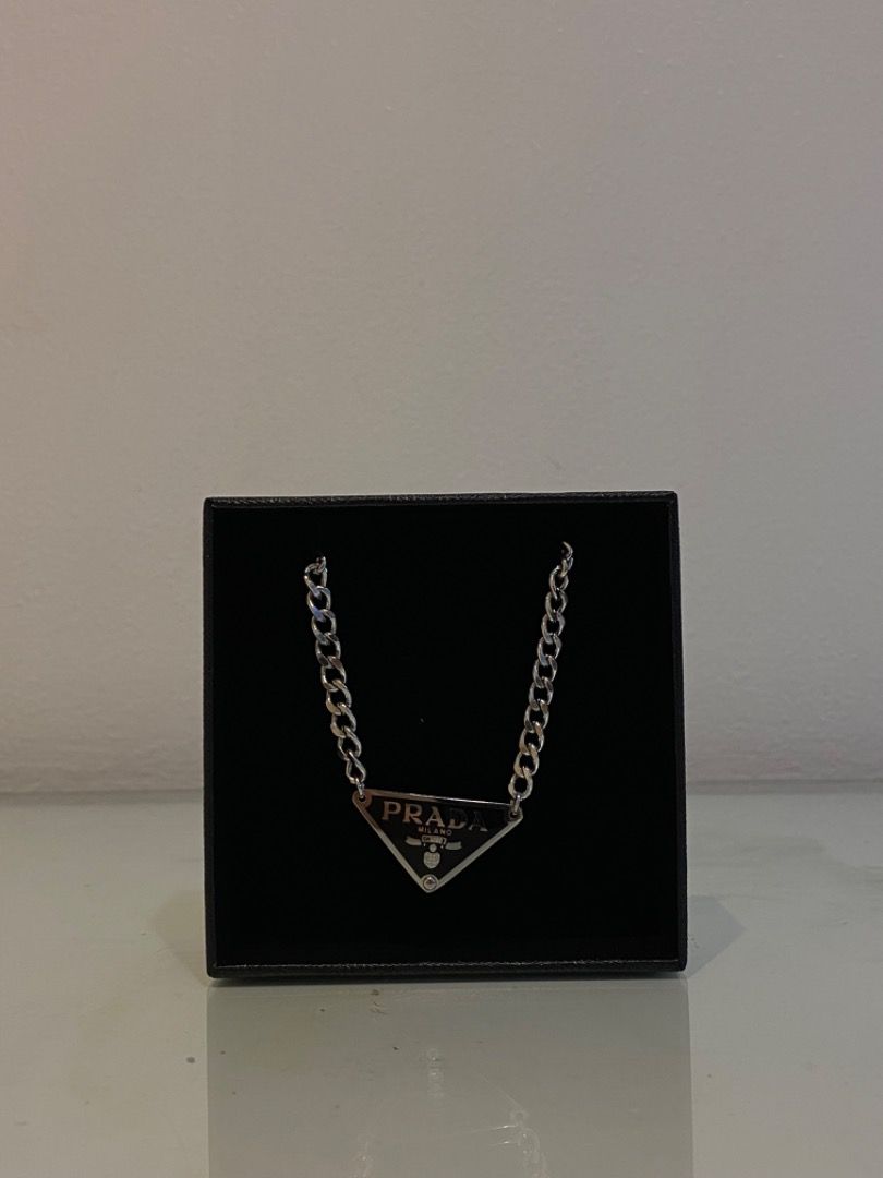 Authentic Reworked Prada Necklace (Category: Luxury Accessories) located in Manila. Submitted by designerarchives.ph (Listing ID 1117604629, Image 3). Description: With box! Pendant will be from thrifted keychains/pouches. 10-15 days Triangle Pendant: Gold Thin chain: black, white, pink Gold Thick chain: black, white Silver Thick chain: black, white, blue, pink, green, brown Heart Pendant: (few left — ₱3999) Gold Chain: red, black, white, bluegre