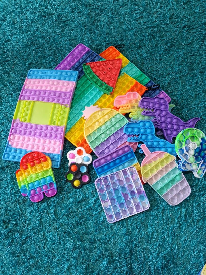 Pop-it Fidget toys (Category: Kids Toys) located in Singapore. Submitted by rainingbabies (Listing ID 1236451623, Image 1). Description: Take all 15 pieces for $18 only. 2 big square ones. 1 big rectangle. 1 ice cream. 1 Watermelon. 1 snail. 3 dinosaurs. 1 pineapple. 2 small squares. 2 fidget spinner pop-it. 1 among us. Self collect at S732784 or Admiralty Mrt Station..