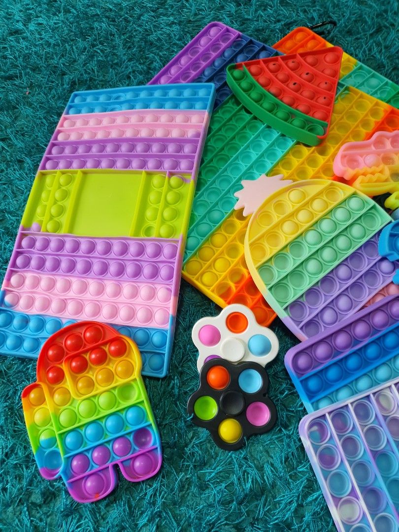 Pop-it Fidget toys (Category: Kids Toys) located in Singapore. Submitted by rainingbabies (Listing ID 1236451623, Image 2). Description: Take all 15 pieces for $18 only. 2 big square ones. 1 big rectangle. 1 ice cream. 1 Watermelon. 1 snail. 3 dinosaurs. 1 pineapple. 2 small squares. 2 fidget spinner pop-it. 1 among us. Self collect at S732784 or Admiralty Mrt Station..