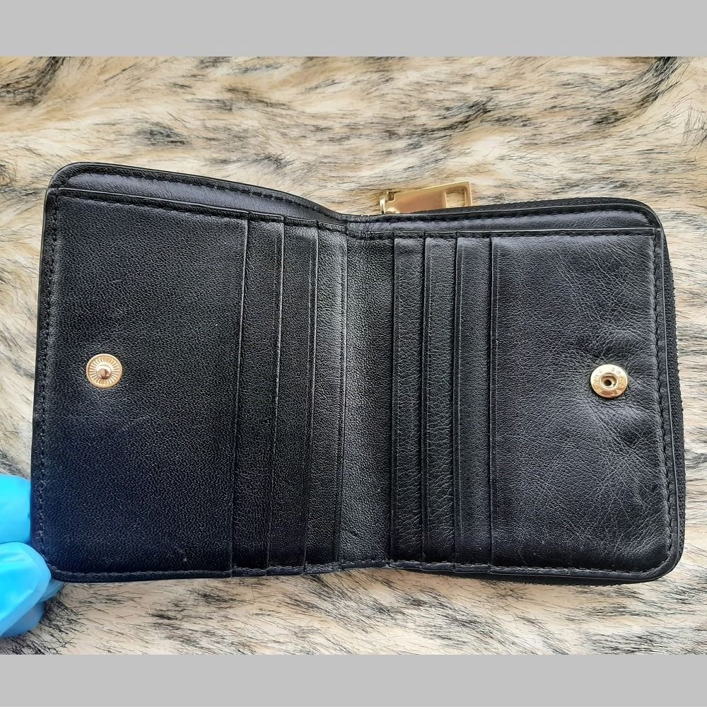 Authentic Marc Jacobs Small Bifold Leather Wallet with Zip Compartment Black Original (Category: Luxury Bags & Wallets) located in Pasig City. Submitted by swing_again_golf (Listing ID 1240489887, Image 3). Description: Brand: Marc Jacobs Genuine Leather Very good condition. Missing metal MJ logo on front (refer to photo). High-quality leatherware. 8 card slots Zip compartment for coins One bill compartment Snap closure.