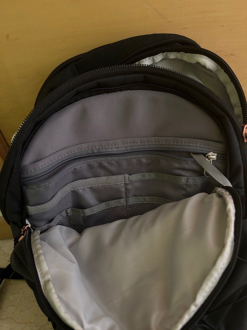 Rose gold and top black north face backpack