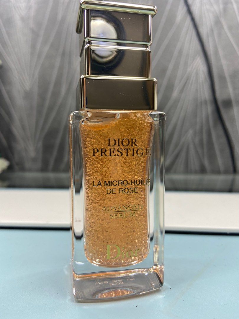 Bottle of Rose Oil Dior Prestige La Micro-huile De Rose on White