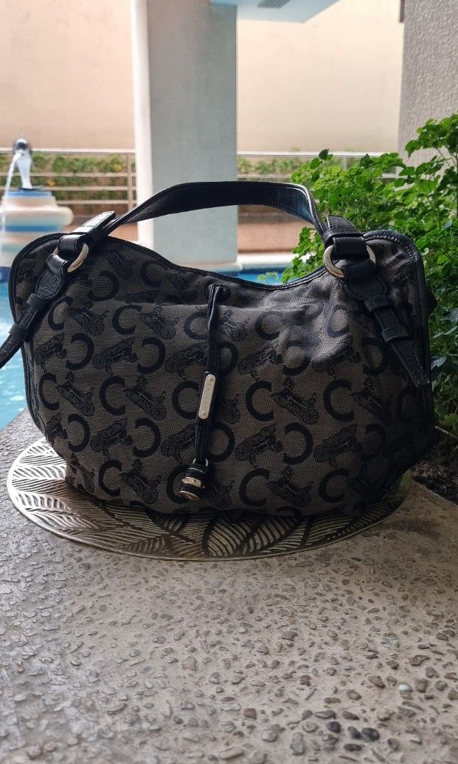 Celine - C Macadam Bittersweet Canvas Hobo Bag (Category: Luxury Bags & Wallets) located in Makati City. Submitted by lilyignacio81 (Listing ID 1242911059, Image 3). Description: From my mom's collection guaranteed Original Introducing you to a true gem from the Celine collection—the Handbag Bitter Sweet Black C Macadam with a Gold C Charm. This extraordinary piece embodies the essence of Celine's commitment to refined aesthetics and impeccable c
