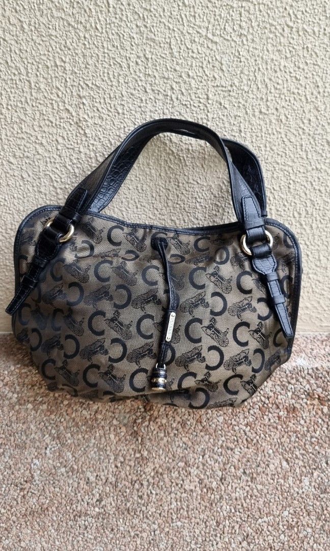 Celine - C Macadam Bittersweet Canvas Hobo Bag (Category: Luxury Bags & Wallets) located in Makati City. Submitted by lilyignacio81 (Listing ID 1242911059, Image 2). Description: From my mom's collection guaranteed Original Introducing you to a true gem from the Celine collection—the Handbag Bitter Sweet Black C Macadam with a Gold C Charm. This extraordinary piece embodies the essence of Celine's commitment to refined aesthetics and impeccable c