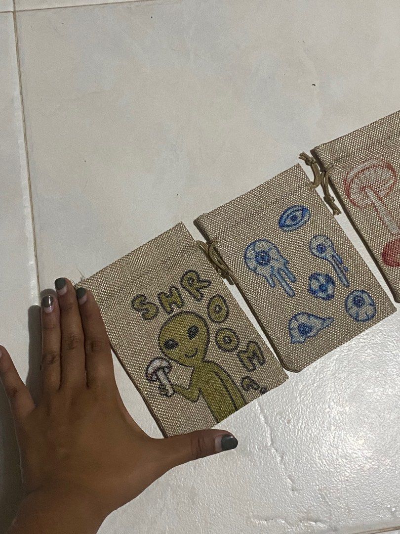 Mini Drawstring bag (Category: Belt bags, Clutches and Pouches) located in Singapore. Submitted by bobbbshop (Listing ID 1242933123, Image 2). Description: Selling all 3 together for $6. Hand drawn for popup but here are some of the leftovers. Still have the plain ones, if you'd like to customise! Just text and I'll price depending on the design..