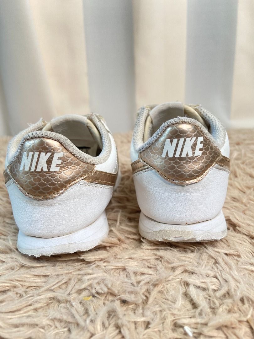 black nike cortez with gold swoosh