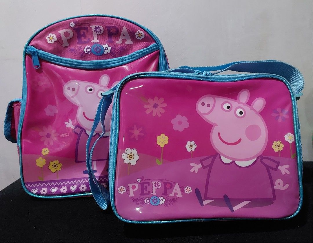 Peppa Pig backpack and lunch bag (Category: Babies & Kids Fashion) located in Antipolo. Submitted by destash4funds (Listing ID 1243047553, Image 1). Description: Peppa Pig backpack and insulated lunch bag condition: preloved - used only a few times size (backpack): height - 11.5in width - 9.5in thickness - 5in size (lunch bag): height - 7.75in width - 9.5in thickness - 3.25in backpack features: zippered front pocket, open inside pocket, 2 side po