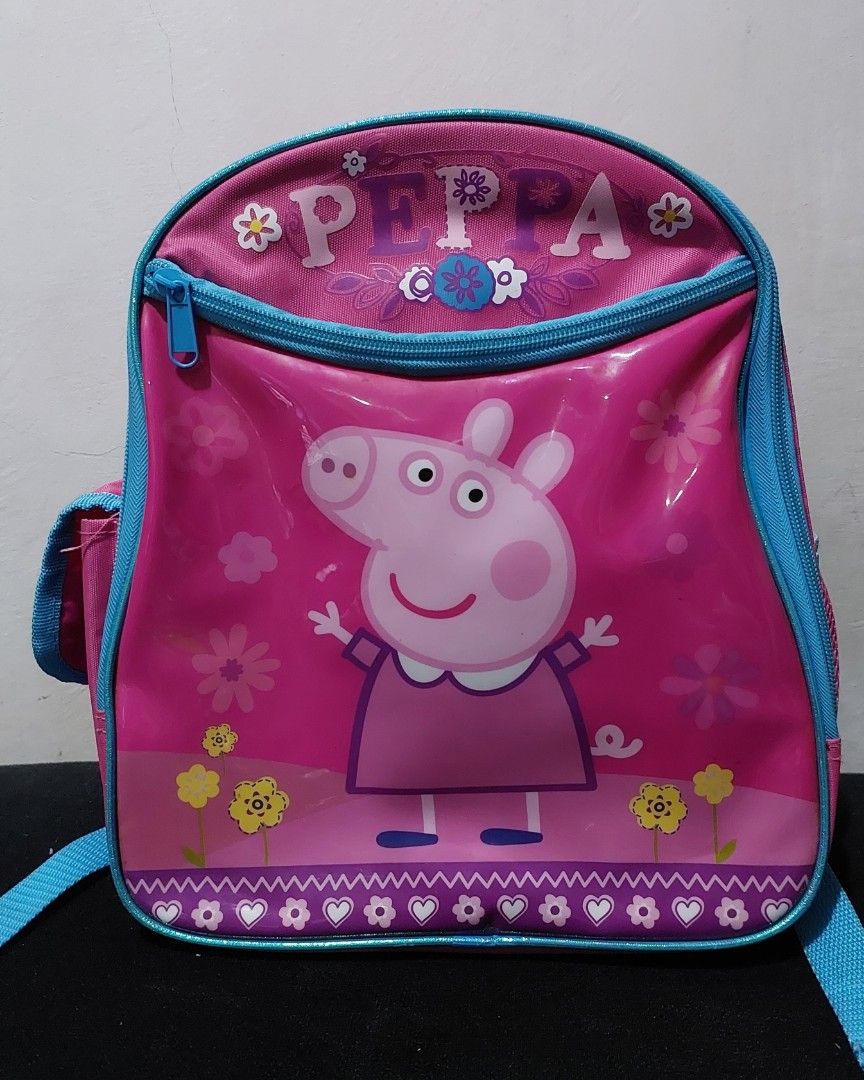 Peppa Pig backpack and lunch bag (Category: Babies & Kids Fashion) located in Antipolo. Submitted by destash4funds (Listing ID 1243047553, Image 2). Description: Peppa Pig backpack and insulated lunch bag condition: preloved - used only a few times size (backpack): height - 11.5in width - 9.5in thickness - 5in size (lunch bag): height - 7.75in width - 9.5in thickness - 3.25in backpack features: zippered front pocket, open inside pocket, 2 side po