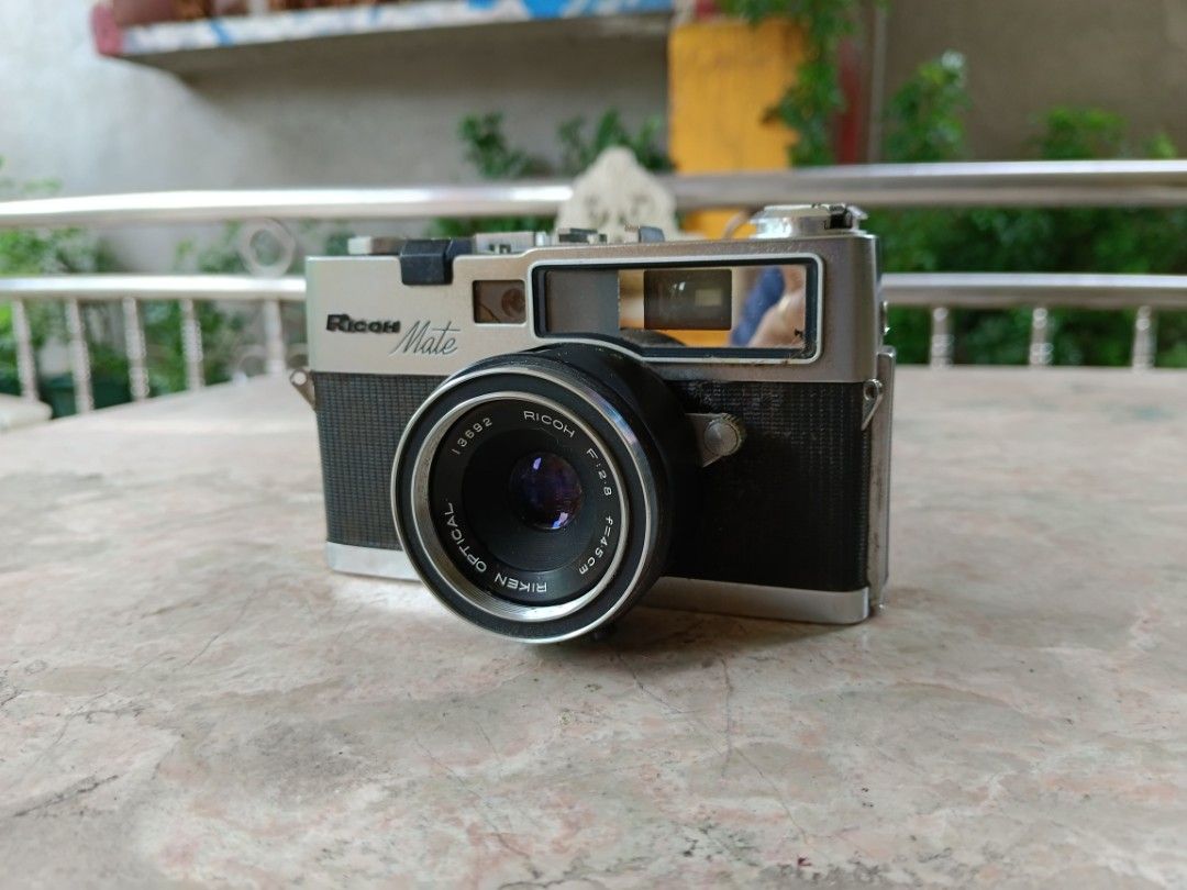 Ricoh Mate Ventage Film Camera (Category: Cameras) located in San Rafael. Submitted by edgardomabalot53 (Listing ID 1242971703, Image 2). Description: Ricoh Mate Ventage Film Camera AS. IS NO TEST ( AS IS Condition, Need to repair, for Parts or Display, Collection Purposes Only) WITH STRAP, LEN'S CAP Original Leather Case.